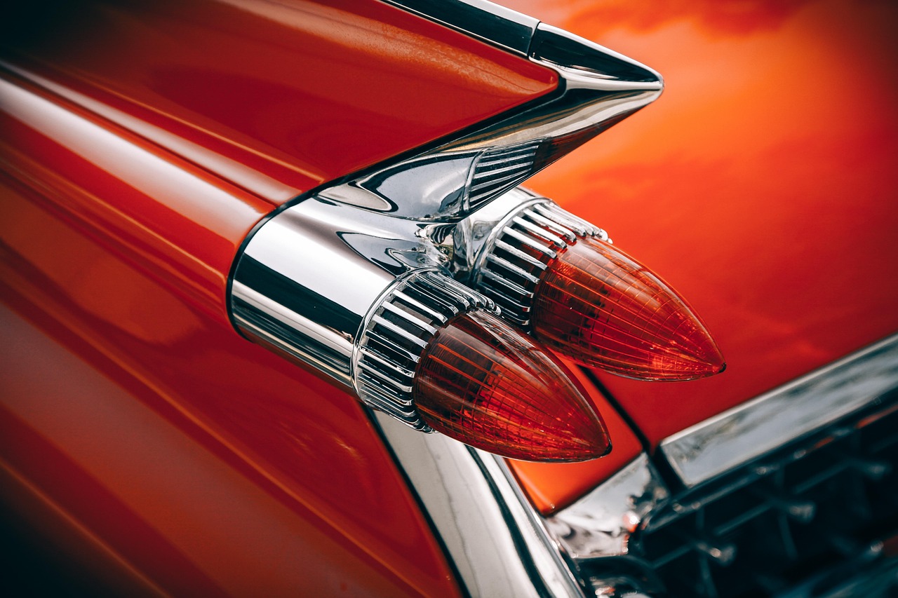 Chrome fins and taillights on a red classic car
